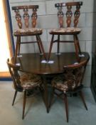 An Ercol oak drop leaf table and 4 dining chairs