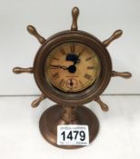 A brass nautical themed clock