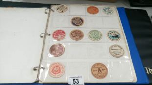 A folder of milk bottle tops, fruit pickers tokens,