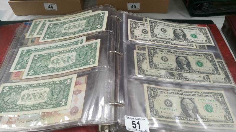 A folder of approximately 85 world bank notes,