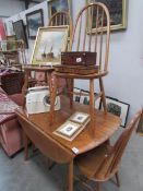 An Ercol style dining table and 4 chairs