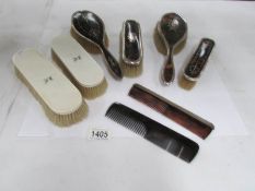 A quantity of silver rimmed brushes and combs etc