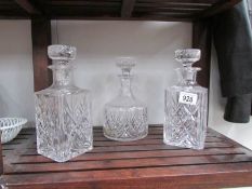 A pair of lead crystal decanters and one other