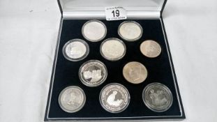 A case of 10 silver world coins (most crown size)