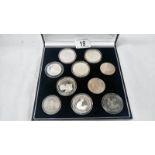 A case of 10 silver world coins (most crown size)