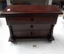 A miniature mahogany chest of drawers