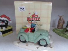 A Royal Doulton Rupert bear and Bill badger in car