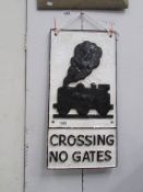 A cast railway sign 'Crossing No Gates'