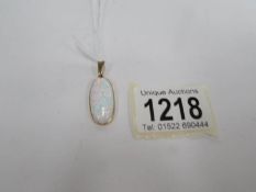 A large yellow gold opal pendant