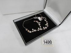 A cased silver necklace set moonstones