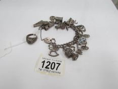 A silver charm bracelet and a silver ring set stones