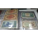 A folder of approximately 100 world bank notes,