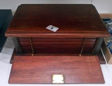 A wooden coin cabinet with 12 drawers and locking front (key in office)