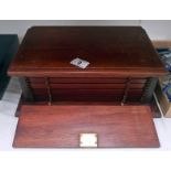 A wooden coin cabinet with 12 drawers and locking front (key in office)
