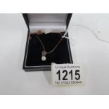 A 9ct yellow gold box link chain with pearl pendant