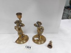 A pair of 19th century brass figural candle holders,