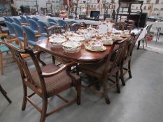 A mahogany extending dining table together with a set of 6 carved mahogany dining chairs