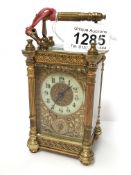 An ornate brass repeater carriage clock