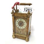 An ornate brass repeater carriage clock