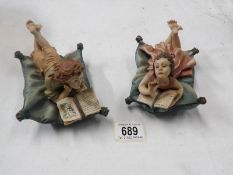 2 Italian Capo-di-monte style figures of children reclining on cushions and reading
