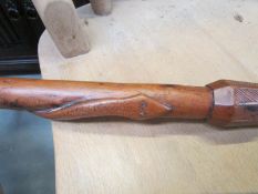 A vintage walking stick carved with an entwined snake