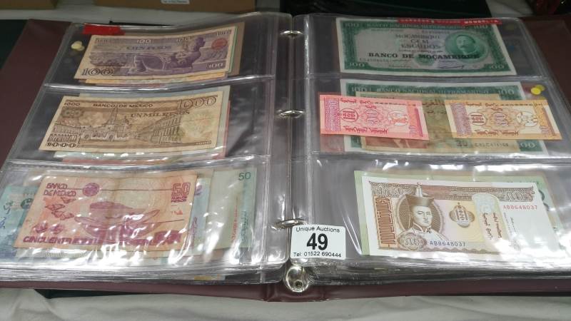 A folder of approximately 120 world bank notes,