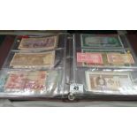 A folder of approximately 120 world bank notes,