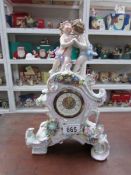 A 'Schieholz' porcelain clock (cherub wings missing)