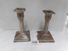 A pair of silver candlesticks (different makers and dates)