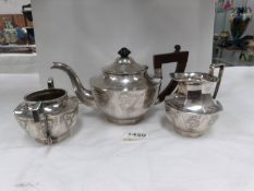 A Chinese silver 3 piece tea set engraved with dragons