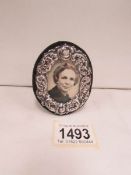 A small oval hall marked silver photo frame