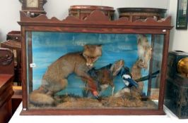A cased taxidermy display of a fox, cockerel,