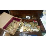 A box of machine and Victorian gambling tokens