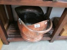 A copper coal scuttle