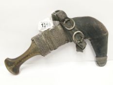 A Jambaya Islamic dagger with rhino horn handle and silver handled scabbard