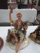 A Capo Di Monte figure of a drinking arab, signed Tosca,