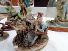 A signed Capo Di Monte figure of Pinocchio being made,