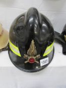 An old fireman's helmet with flame emblem
