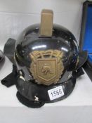 A fireman's helmet with brass emblem