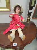A Victorian bisque headed doll marked S H with PB in a star,