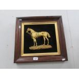 A brass profile of a horse in rosewood frame