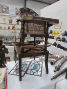 A 19th century child's high chair that converts to a play table and chair