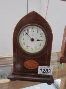 A mahogany inlaid arched top mantel clock