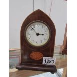 A mahogany inlaid arched top mantel clock