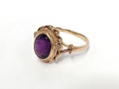 Am amethyst set gold ring in a twisted collet setting