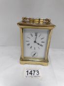 An old brass carriage alarm clock in working order,