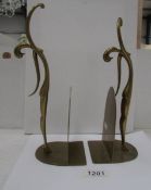 A pair of brass figural bookends