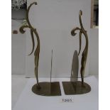 A pair of brass figural bookends