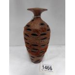An unusual oriental vase carved from a seed pod