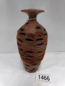 An unusual oriental vase carved from a seed pod